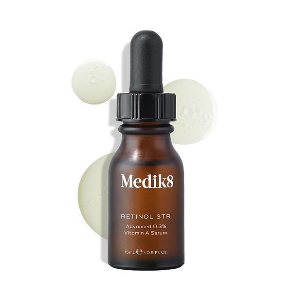 Medik8 Retinol 3TR serum bottle displayed against a clean white background with translucent serum droplets. The amber glass bottle with a black dropper cap features the Medik8 logo and is labeled "RETINOL 3TR Advanced 0.3% Vitamin A Serum" in a 15mL size.