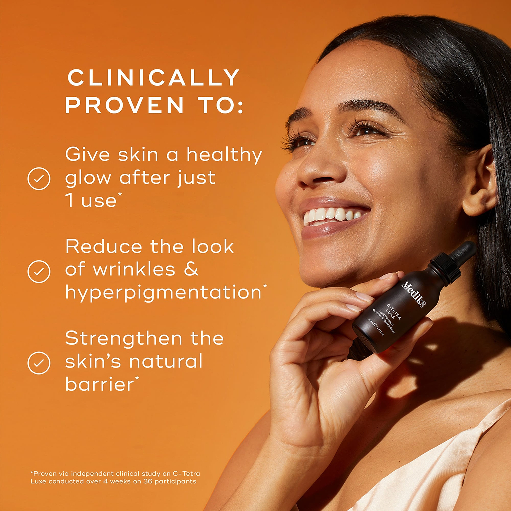 Close-up of a person's face being treated with a glass pipette, set against a dark, warm-toned background. The text states the product is "CLINICALLY PROVEN TO:" followed by three check-marked claims: "Give skin a healthy glow after just 1 use*", "Reduce the look of wrinkles & hyperpigmentation*", and "Strengthen the skin's natural barrer". A footer note specifies these results are proven via an independent clinical study.
