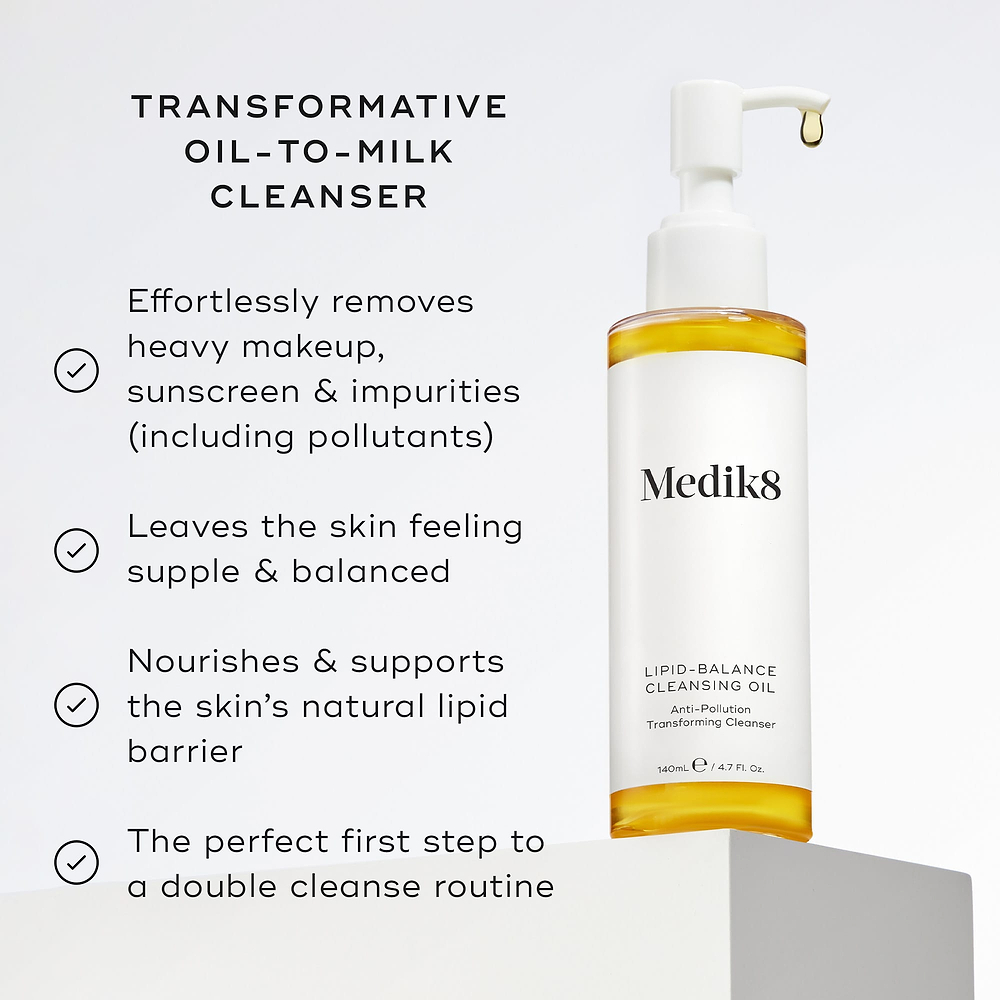 Lipid-Balance Cleansing Oil bottle stands on a white block. Text lists benefits including removing heavy makeup, supporting the lipid barrier, and acting as a transformative oil-to-milk cleanser.