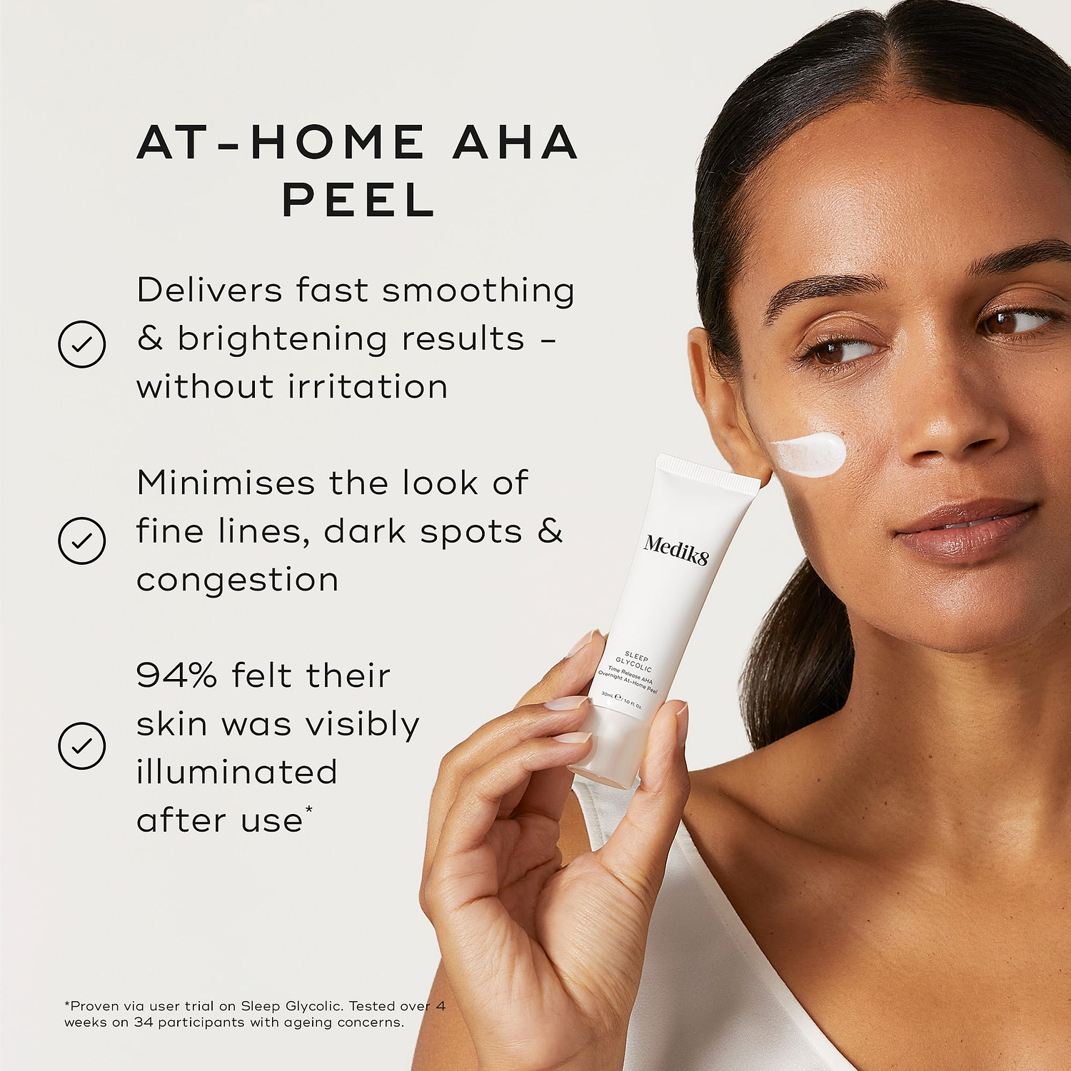 A person holds a Medik8 Sleep Glycolic tube against a neutral off-white background with a swipe of white cream on their cheek. Text highlights its benefits as an "At-Home AHA Peel" that "delivers fast smoothing & brightening results – without irritation" and "minimises the look of fine lines, dark spots & congestion." It also notes "94% felt their skin was visibly illuminated after use."