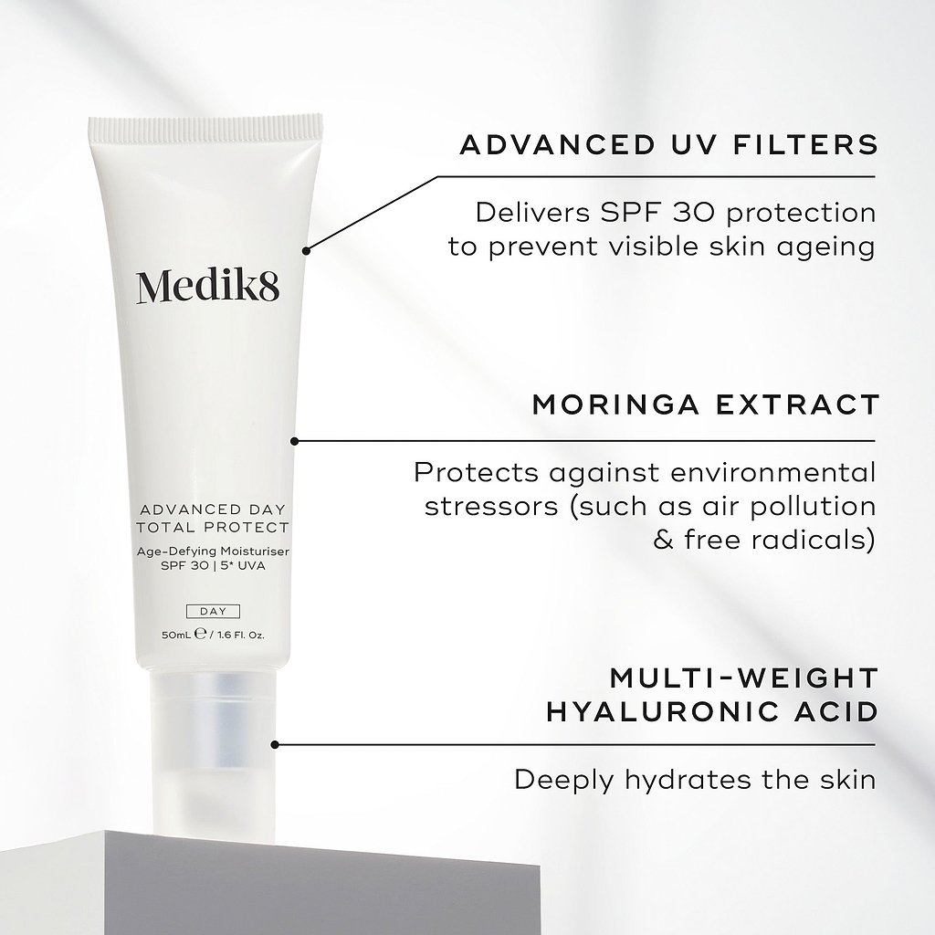 Medik8 Advanced Day Total Protect tube stands on a white block against a clean grey background. Text highlights key ingredients: Advanced UV Filters to deliver SPF 30 protection and prevent visible skin ageing, Moringa Extract to protect against environmental stressors like air pollution and free radicals, and Multi-Weight Hyaluronic Acid to deeply hydrate the skin.