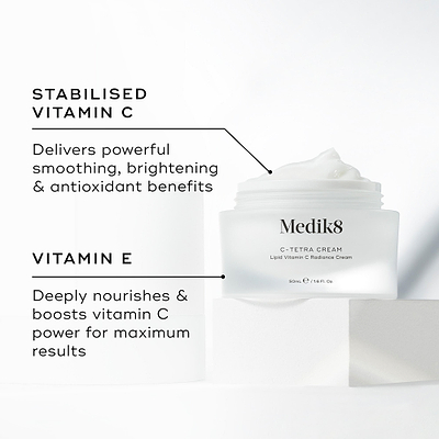 Medik8 C-Tetra Cream jar displayed open on a white stone block against a clean white background. The image features two key ingredients and their benefits:

STABILISED VITAMIN C: Delivers powerful smoothing, brightening, and antioxidant benefits.

VITAMIN E: Deeply nourishes and boosts vitamin C power for maximum results.