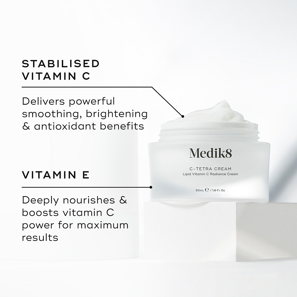 Medik8 C-Tetra Cream jar displayed open on a white stone block against a clean white background. The image features two key ingredients and their benefits:

STABILISED VITAMIN C: Delivers powerful smoothing, brightening, and antioxidant benefits.

VITAMIN E: Deeply nourishes and boosts vitamin C power for maximum results.