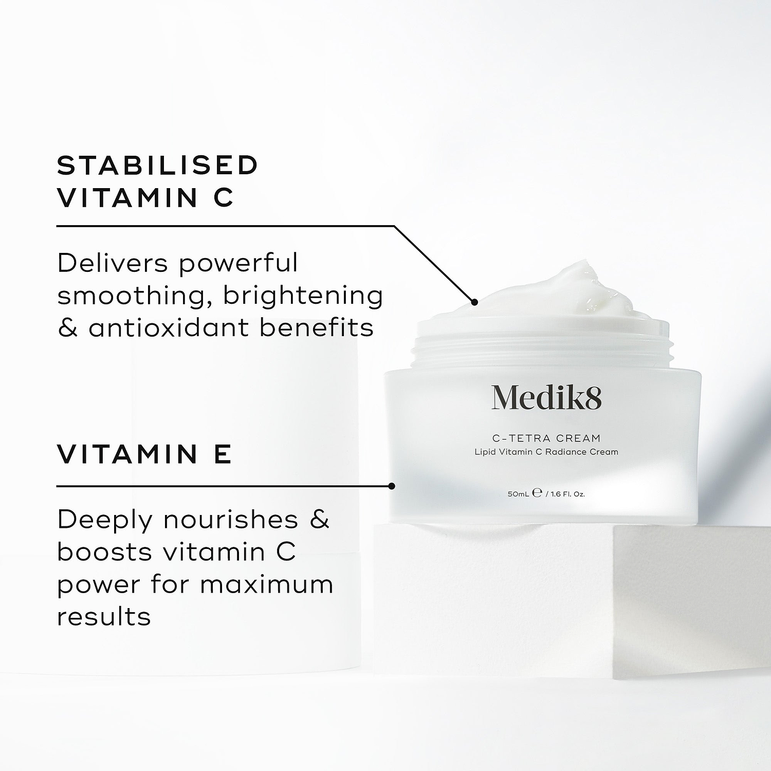 Medik8 C-Tetra Cream jar displayed open on a white stone block against a clean white background. The image features two key ingredients and their benefits:

STABILISED VITAMIN C: Delivers powerful smoothing, brightening, and antioxidant benefits.

VITAMIN E: Deeply nourishes and boosts vitamin C power for maximum results.