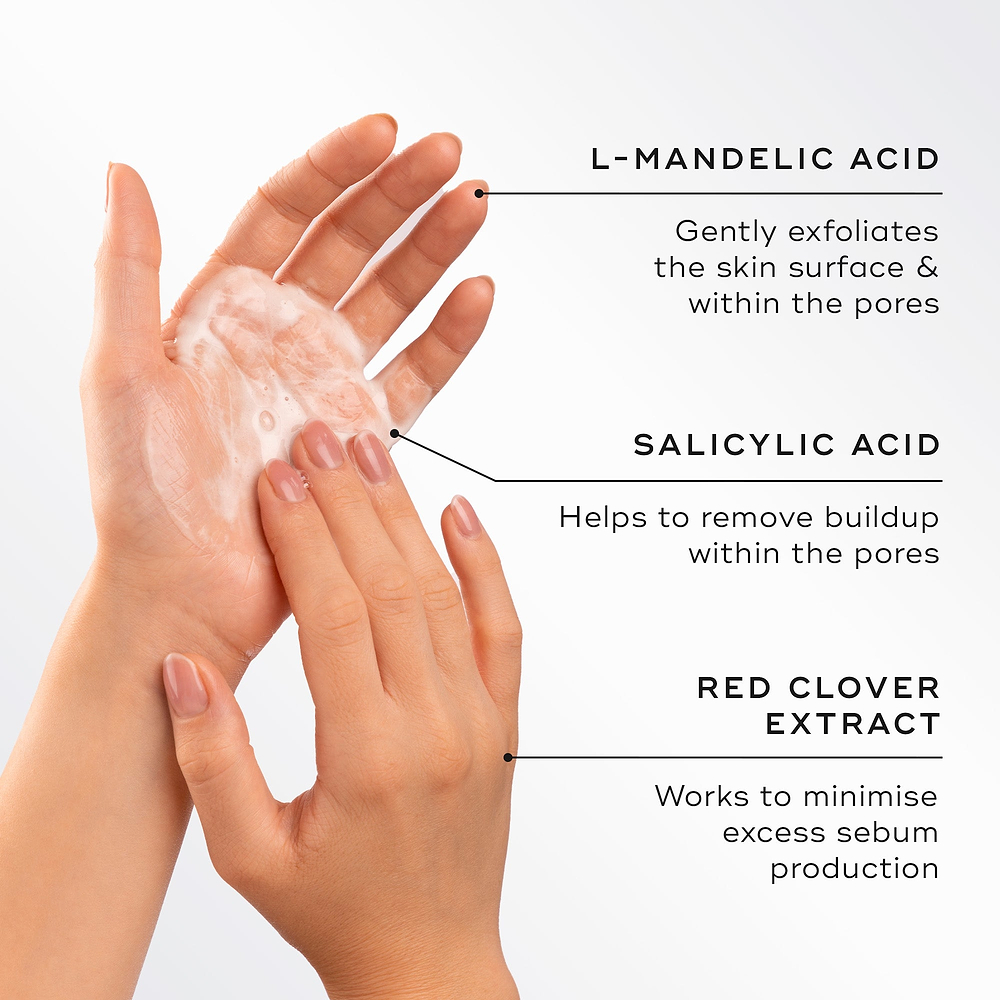 Two hands lather the cleanser into a foam next to text detailing key ingredients. Highlights include L-Mandelic Acid to gently exfoliate, Salicylic Acid to remove buildup within pores, and Red Clover Extract to minimise excess sebum production.