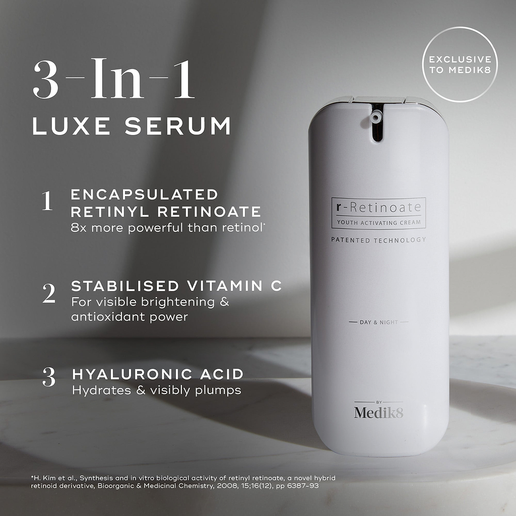 A large white cylindrical airless pump dispenser bottle of Medik8 r-Retinoate® Day & Night stands vertically against a light grey minimalist background with subtle shadows. Text overlays on the left highlight its key features as a "3-In-1 LUXE SERUM":

"ENCAPSULATED RETINYL RETINOATE 8x more powerful than retinol*"

"STABILISED VITAMIN C For visible brightening & antioxidant power"

"HYALURONIC ACID Hydrates & visibly plumps"
A circular badge at the top right indicates "EXCLUSIVE TO Medik8". 