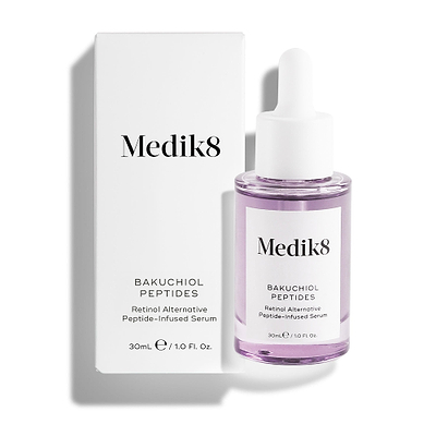Medik8 Bakuchiol Peptides serum bottle filled with purple liquid stands alongside its white outer carton against a clean white background. Text on the packaging identifies it as a "Retinol Alternative Peptide-Infused Serum."
