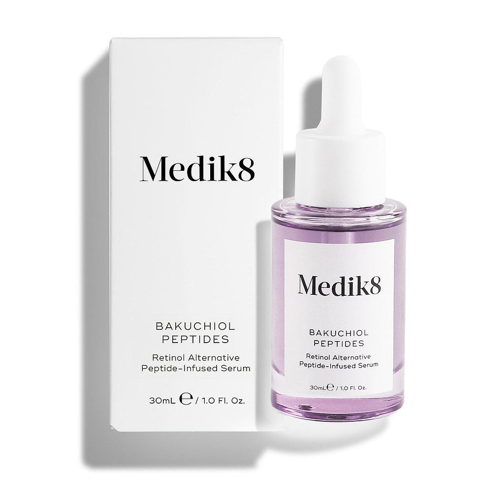 Medik8 Bakuchiol Peptides serum bottle filled with purple liquid stands alongside its white outer carton against a clean white background. Text on the packaging identifies it as a "Retinol Alternative Peptide-Infused Serum."