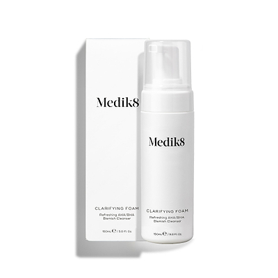 Medik8 Clarifying Foam pump bottle stands next to its matching white outer carton on a clean white background. Text on both identifies the product as a 150mL Refreshing AHA/BHA Blemish Cleanser.