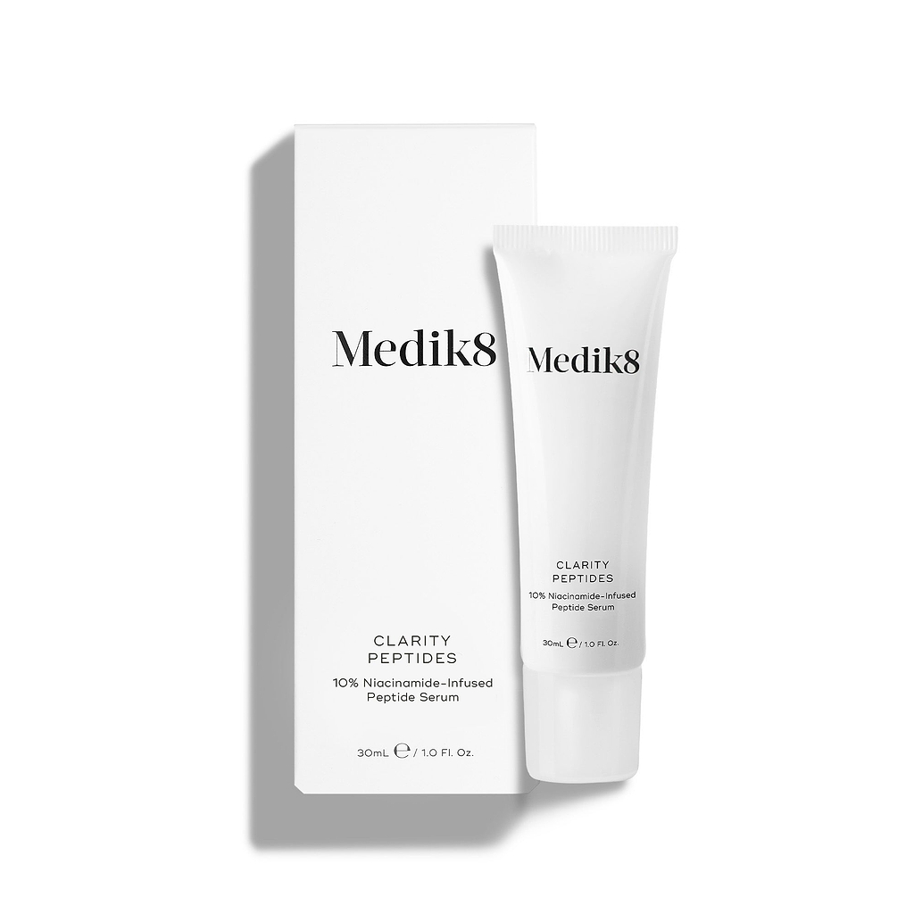 Medik8 Clarity Peptides tube stands next to its white packaging carton on a white background. Text identifies it as a "10% Niacinamide-Infused Peptide Serum" in a 30mL size.