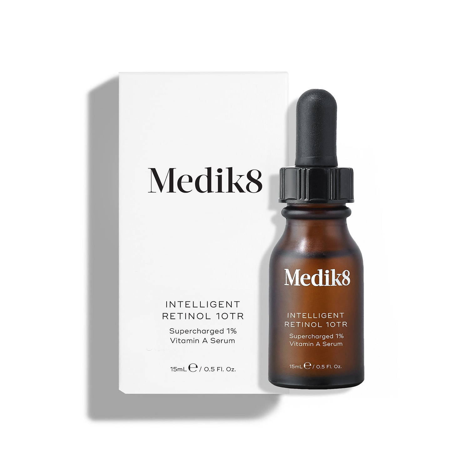 Medik8 Intelligent Retinol 10TR serum bottle stands in front of its matching white product carton on a clean white background. Text identifies the product as a 15mL "Supercharged 1% Vitamin A Serum."