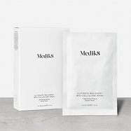 A white cardboard box of Medik8 Ultimate Recovery Bio-Cellulose Mask standing next to a single white sachet on a textured grey surface against a clean white background. Text indicates the box contains 6 sheet masks.