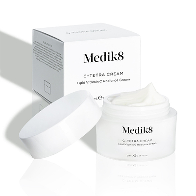 Medik8 C-Tetra Cream jar and its white cardboard carton displayed on a clean white background with soft shadows. The open white, frosted-glass jar features the Medik8 logo and is labelled "C-TETRA CREAM Lipid Vitamin C Radiance Cream" in a 50mL size. A thick swirl of white cream is visible on top of the jar, with the white box behind it showing the product name and a partial ingredients list.