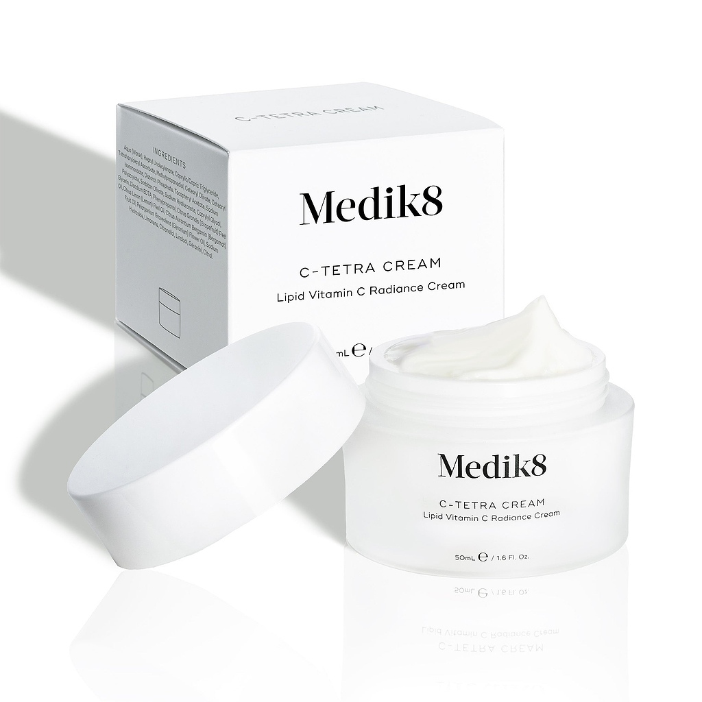 Medik8 C-Tetra Cream jar and its white cardboard carton displayed on a clean white background with soft shadows. The open white, frosted-glass jar features the Medik8 logo and is labelled "C-TETRA CREAM Lipid Vitamin C Radiance Cream" in a 50mL size. A thick swirl of white cream is visible on top of the jar, with the white box behind it showing the product name and a partial ingredients list.
