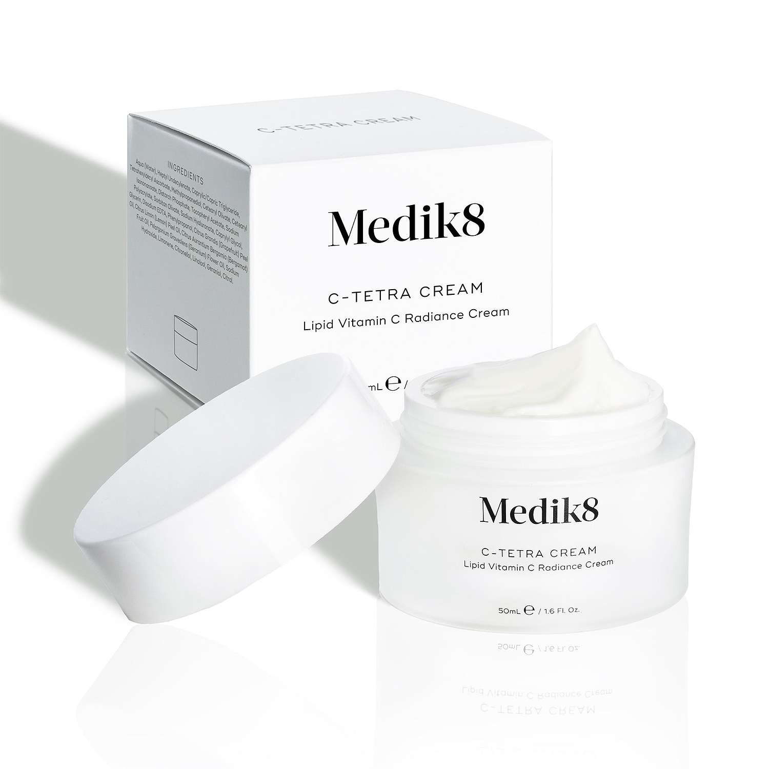Medik8 C-Tetra Cream jar and its white cardboard carton displayed on a clean white background with soft shadows. The open white, frosted-glass jar features the Medik8 logo and is labelled "C-TETRA CREAM Lipid Vitamin C Radiance Cream" in a 50mL size. A thick swirl of white cream is visible on top of the jar, with the white box behind it showing the product name and a partial ingredients list.