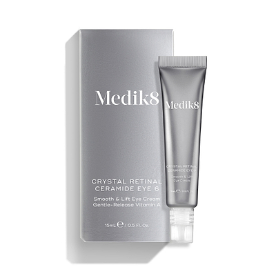 A silver tube of Crystal Retinal Ceramide Eye 6 is shown standing beside its matching silver carton.