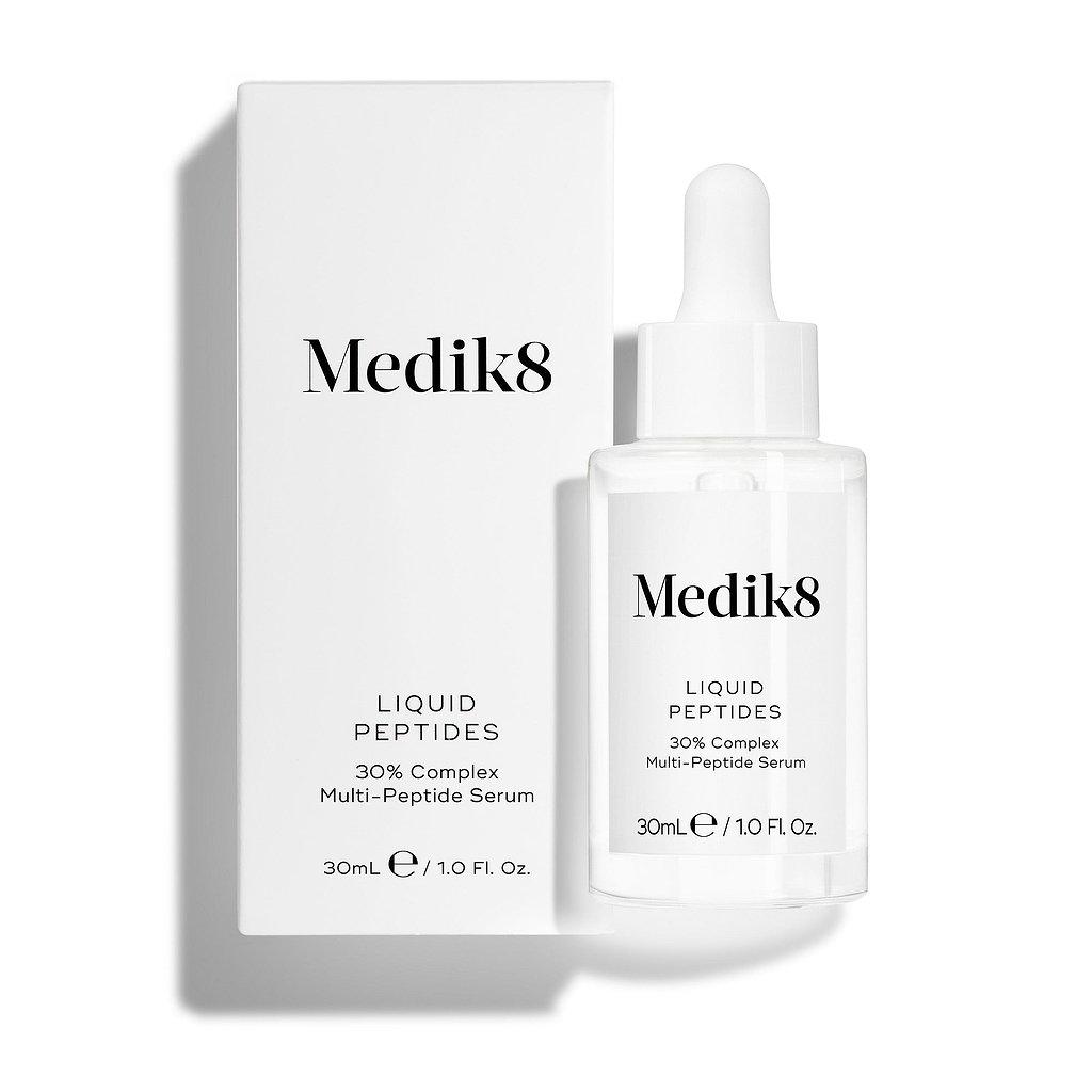 A clear glass dropper bottle of Liquid Peptides serum stands in front of its white product carton.
