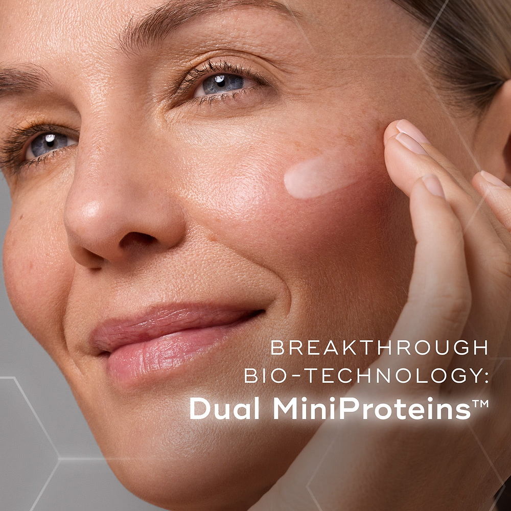  A woman is shown applying liquid peptides advanced MP to  the cheek. Text overlays the image, highlighting "BREAKTHROUGH BIO-TECHNOLOGY: Dual MiniProteins™.