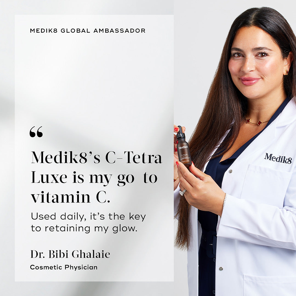 Dr. Bibi Ghalaie, Cosmetic Physician, smiles while wearing a white Medik8 lab coat and holding a brown bottle of C-Tetra Luxe. A quote beside her states: "Medik8’s C-Tetra Luxe is my go to vitamin C. Used daily, it’s the key to retaining my glow.".