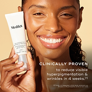 Close-up of a smiling woman with a radiant complexion holding a tube of Advanced Day Ultimate Protect. Text states: "CLINICALLY PROVEN to reduce visible hyperpigmentation & wrinkles in 4 weeks."