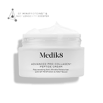 An open jar of Medik8 Advanced Pro-Collagen+ Peptide Cream displaying a swirl of white cream on a clean white background. Text on the jar describes it as a "Rejuvenating Anti-Wrinkle Moisturiser with GF MiniProtein & NAD+ Boost". A graphic in the top left corner highlights "GF MINIPROTEINS™ & NAD+ LONGEVITY BOOSTER".