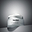 A professional photograph of an open jar of Advanced Pro-Collagen Peptide Cream, revealing its smooth white texture, resting on a grey geometric surface against a grey gradient background. Below the image, clear text identifies this product category as ‘Moisturisers’.
