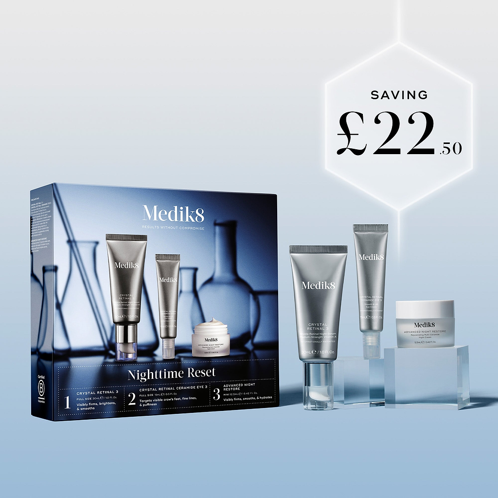 The Medik8 Nighttime Reset kit box and products displayed on clear blocks against a blue background. A glowing hexagonal graphic highlights a saving of "£22.50."