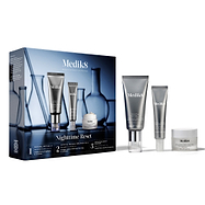 The Medik8 Nighttime Reset kit box displayed next to its contents: Crystal Retinal 3, Crystal Retinal Ceramide Eye 3, and Advanced Night Restore. The blue box features lab glassware graphics and lists the benefits of the 3-step routine. 