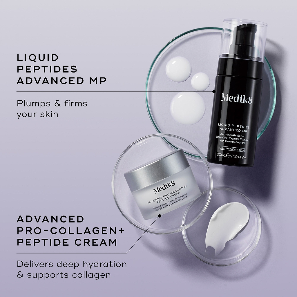 An overhead shot of the Peptide Boosters duo—Liquid Peptides Advanced MP and Advanced Pro-Collagen+ Peptide Cream—arranged with petri dishes showing white serum droplets and a smear of white cream against a lilac background. Text links each product to its benefit: "Plumps & firms your skin" and "Delivers deep hydration & supports collagen."