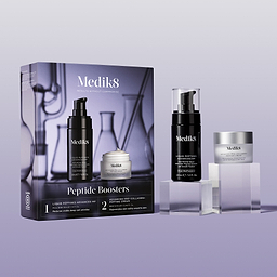 Medik8 Peptide Boosters gift set displayed against a lavender background. A black Liquid Peptides Advanced MP pump bottle and Advanced Pro-Collagen+ Peptide Cream mini jar sit on clear blocks next to their purple branded box, which shows a faint laboratory glassware design. Text on the box details the products inside.