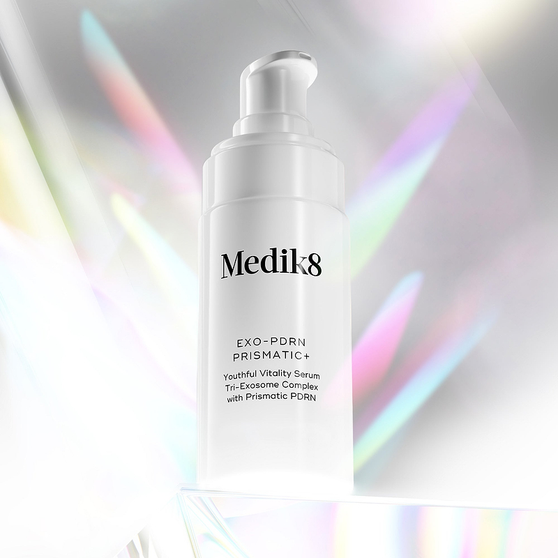 Exo PDRN Prismatic+ bottle with colorful light effects on a white background