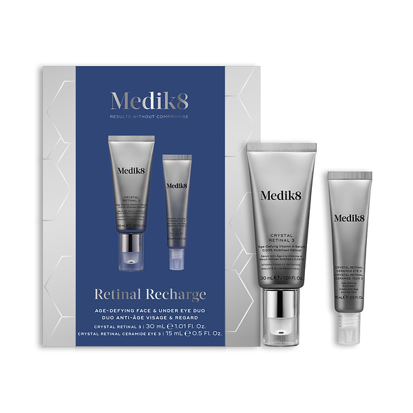 A Medik8 "Retinal Recharge" gift box displayed on a white background with a dark blue center and hexagonal graphics, showing the printed products inside. A Crystal Retinal 3 tube and a Crystal Retinal Ceramide Eye 3 tube stand loose beside the box.