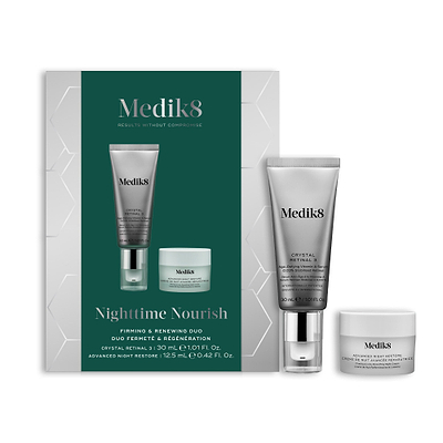 A Medik8 "Nighttime Nourish" gift box displayed on a white background with a dark green center and hexagonal graphics, showing the printed products inside. A Crystal Retinal 3 tube and an Advanced Night Restore travel size jar stand loose beside the box.