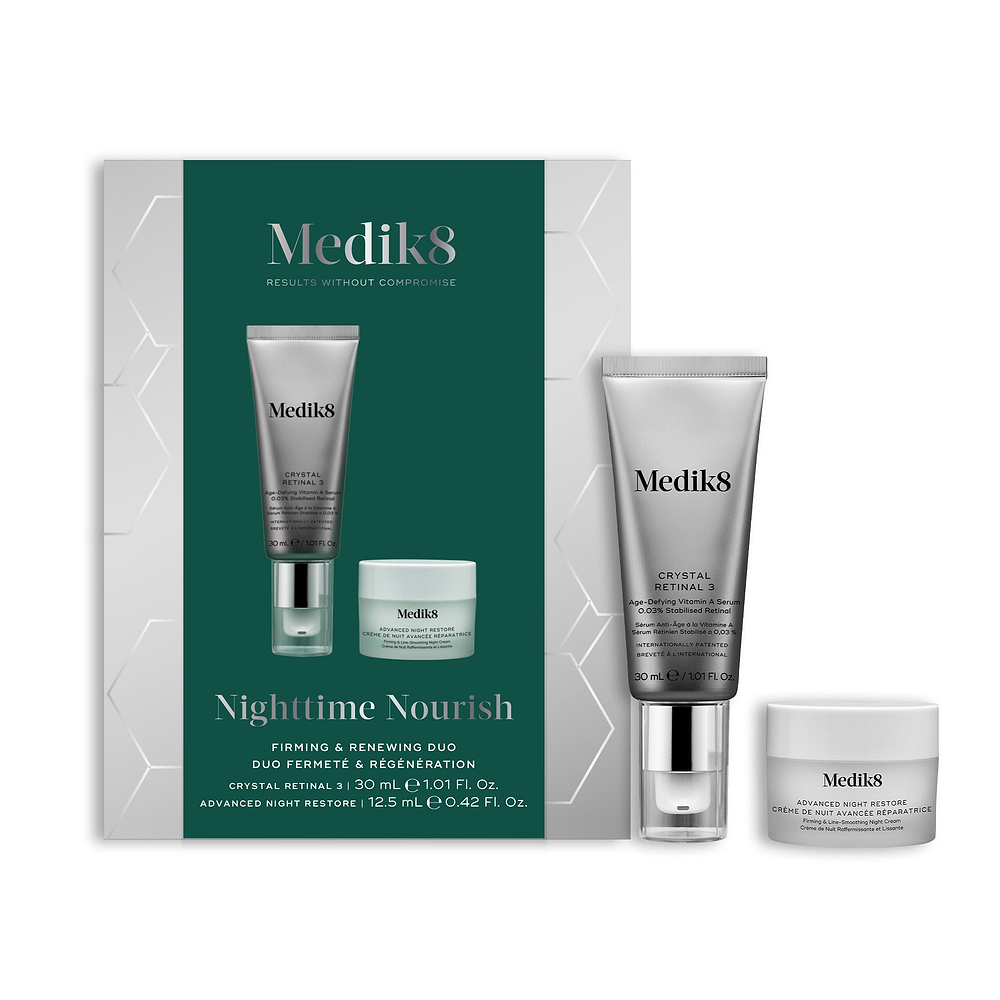 A Medik8 "Nighttime Nourish" gift box displayed on a white background with a dark green center and hexagonal graphics, showing the printed products inside. A Crystal Retinal 3 tube and an Advanced Night Restore travel size jar stand loose beside the box.