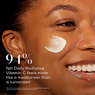 Close-up profile of a smiling model with a smear of cream on her cheek. Bold text states that 94% felt Daily Radiance Vitamin C feels more like a moisturiser than a sunscreen.