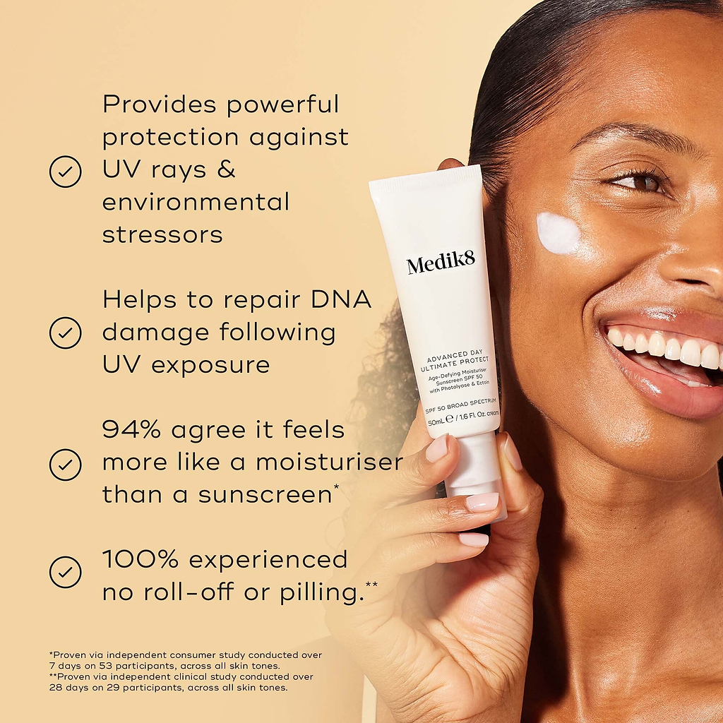 Medik8 Advanced Day Ultimate Protect cream tube is held by a smiling model with a swipe of white cream on her cheek against a warm beige background. Text highlights four key benefits: powerful protection against UV rays and environmental stressors, DNA damage repair following UV exposure, 94% agree it feels like a moisturiser, and 100% experienced no roll-off or pilling.