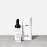Medik8 Hydr8 B5 travel-sized serum bottle stands next to its matching white product carton on a grey textured surface against a neutral background. Text on the 8mL bottle identifies it as a "Liquid Rehydration Serum."