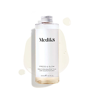 A 200mL clear refill bottle of Medik8 Press & Glow exfoliating tonic featuring a silver screw cap. Set against a white background, the bottle sits amidst a puddle and droplets of the pale yellow tonic, showcasing its liquid texture. The label text reads "Daily Exfoliating PHA Tonic with Enzyme Activator."