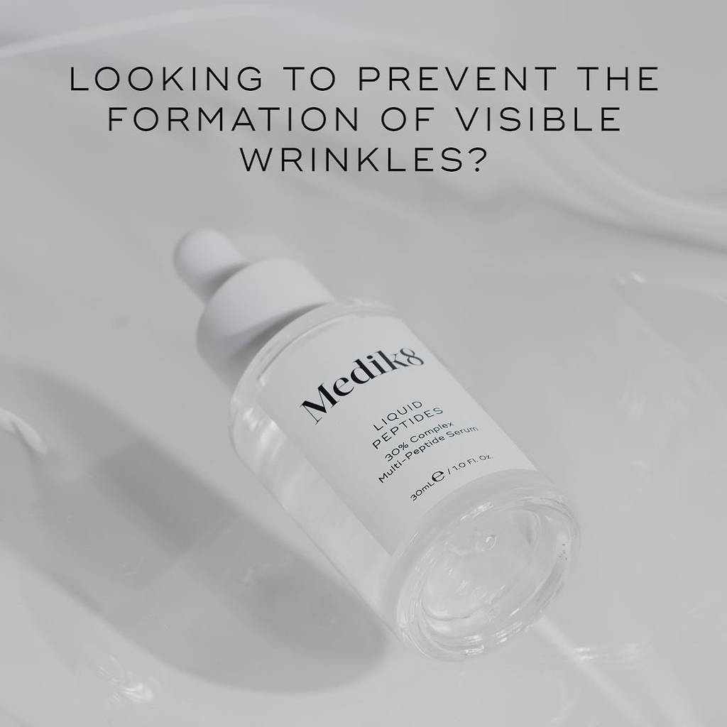 A promotional video for Medik8 Liquid Peptides serum. Text overlays ask "Looking to prevent the formation of visible wrinkles?" and highlight the "30% Complex Multi-Peptide Serum" formula. A model applies the clear liquid serum to her face and neck, with text stating it is "Proven to visibly reduce fine lines & wrinkles in 4 weeks*". Key ingredients like "Matrixyl 3000" and "Drone-Targeted Copper Peptide" are listed alongside the bottle.