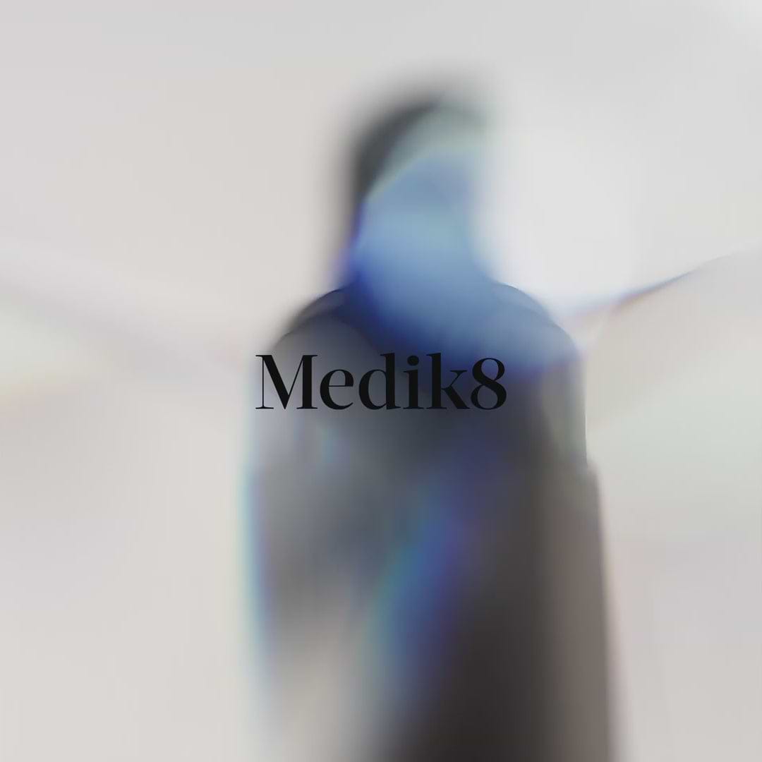 A promotional video for Medik8 Exo-PDRN Prismatic+ Face Serum in a white pump bottle against a light holographic background. A woman applies the clear serum to her cheek. Text highlights claims: "Boost skin's natural rejuvenation by over 50%," "Vegan Prismatic PDRN," and "Up to 151 billion exosomes per bottle" alongside 3D animations of DNA strands and cells. A checklist notes benefits including Volume and Luminosity. It ends with the woman holding the bottle near the Medik8 and B Corp logos.