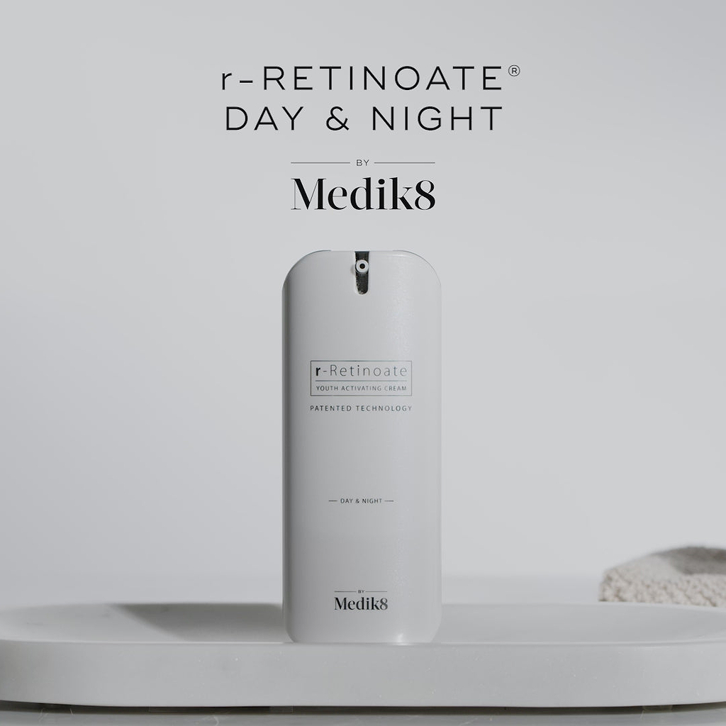 A video features the Medik8 r-Retinoate® Day & Night airless pump bottle. Text says "GROUNDBREAKING 3 IN 1 LUXE SERUM" that stimulates collagen and skin cell turnover with stabilized vitamin C and multi-weight hyaluronic acid. It claims to be "8X MORE POWERFUL THAN STANDARD RETINOL*," yet "POWERFUL YET GENTLE, EVEN ON SENSITIVE SKIN." The video shows application on a hand, confirms use "both morning & night," promises visibly reduced lines and wrinkles, and suggests pairing with r-Retinoate Day & Night Eye.