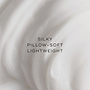 Flowing cream textured background whilst video plays following text: 'silky, pillow-soft, lightweight.'